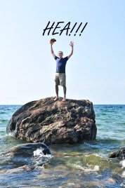 Man stranded on a rock in ocean